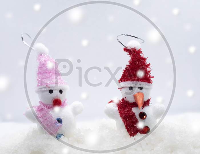 Merry Christmas And Happy New Year Greeting Card With Copy-Space.Two Snowmen Standing In Winter Christmas Landscape.Winter Background