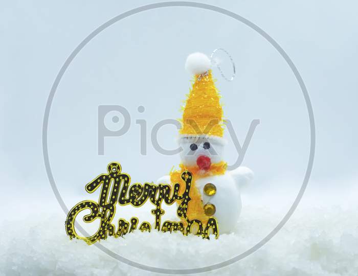Merry Christmas And Happy New Year Greeting Card. Cheerful Snowman Standing In The Winter On The Christmas Landscape. Merry Christmas Lettering
