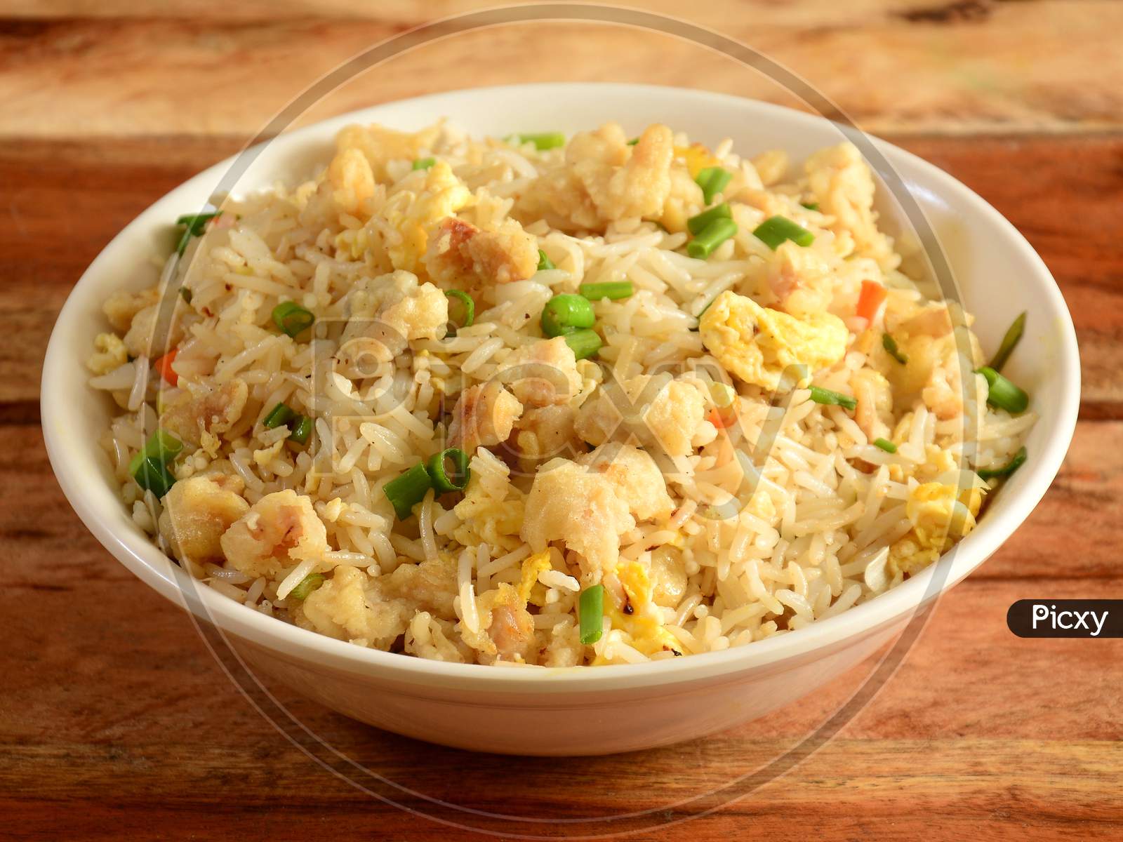 Indian Cuisine Healthy And Tasty Chicken Fried Rice Served In White Bowl Over A Rustic Wooden Background, Selective Focus