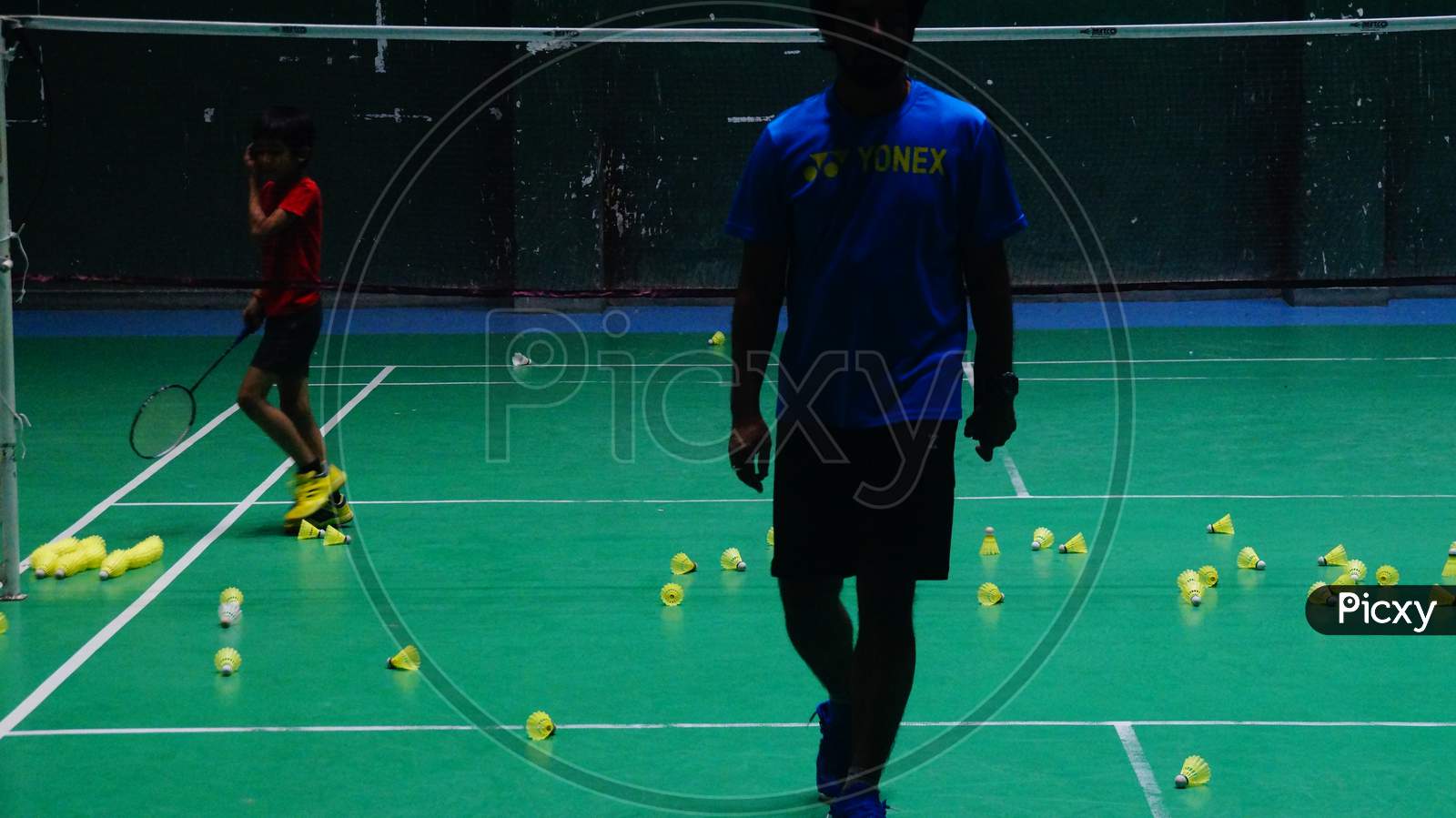 Badminton Coach coming out of court after completion of training session