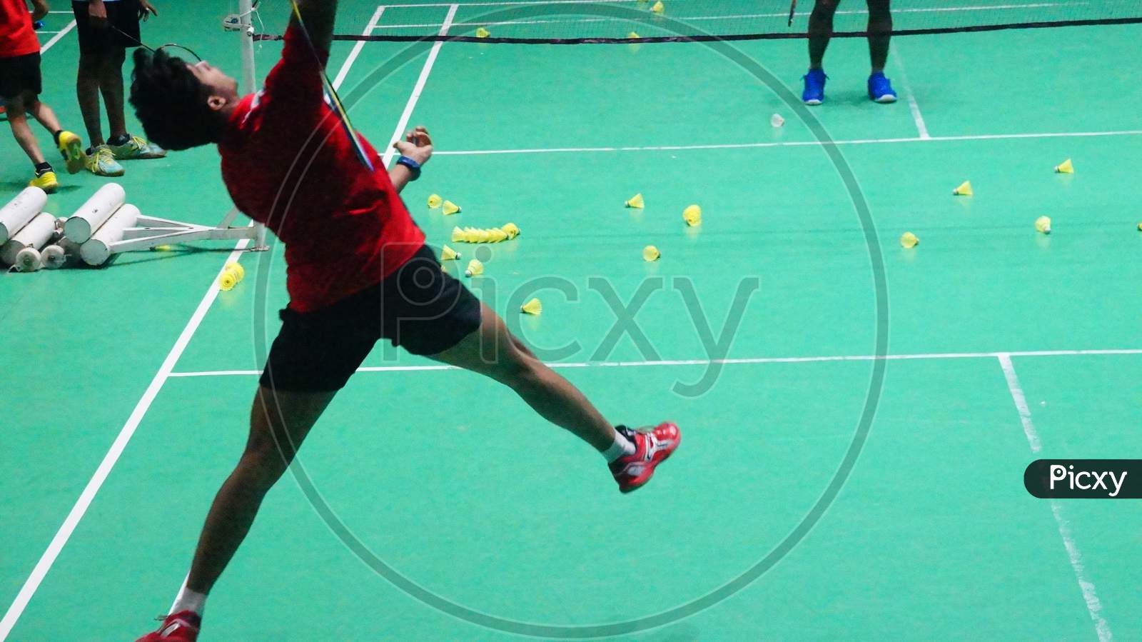 Image of Badminton Player attempting Over head straight strokes