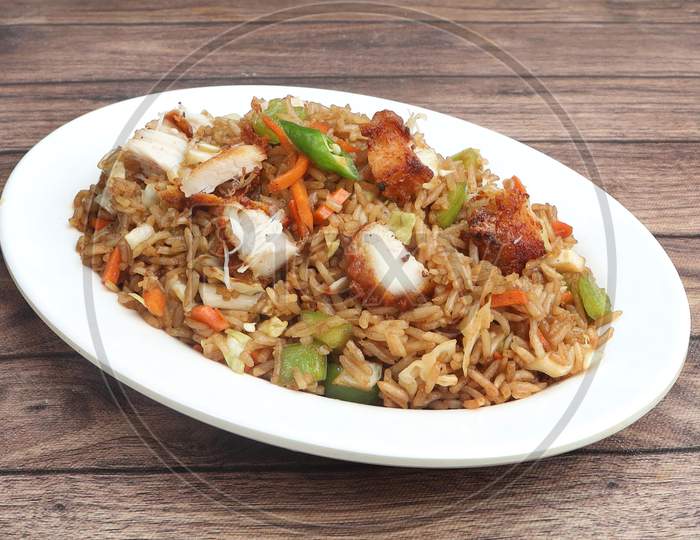 Indian Cuisine Healthy And Tasty Chicken Fried Rice Served In White Bowl Over A Rustic Wooden Background, Selective Focus