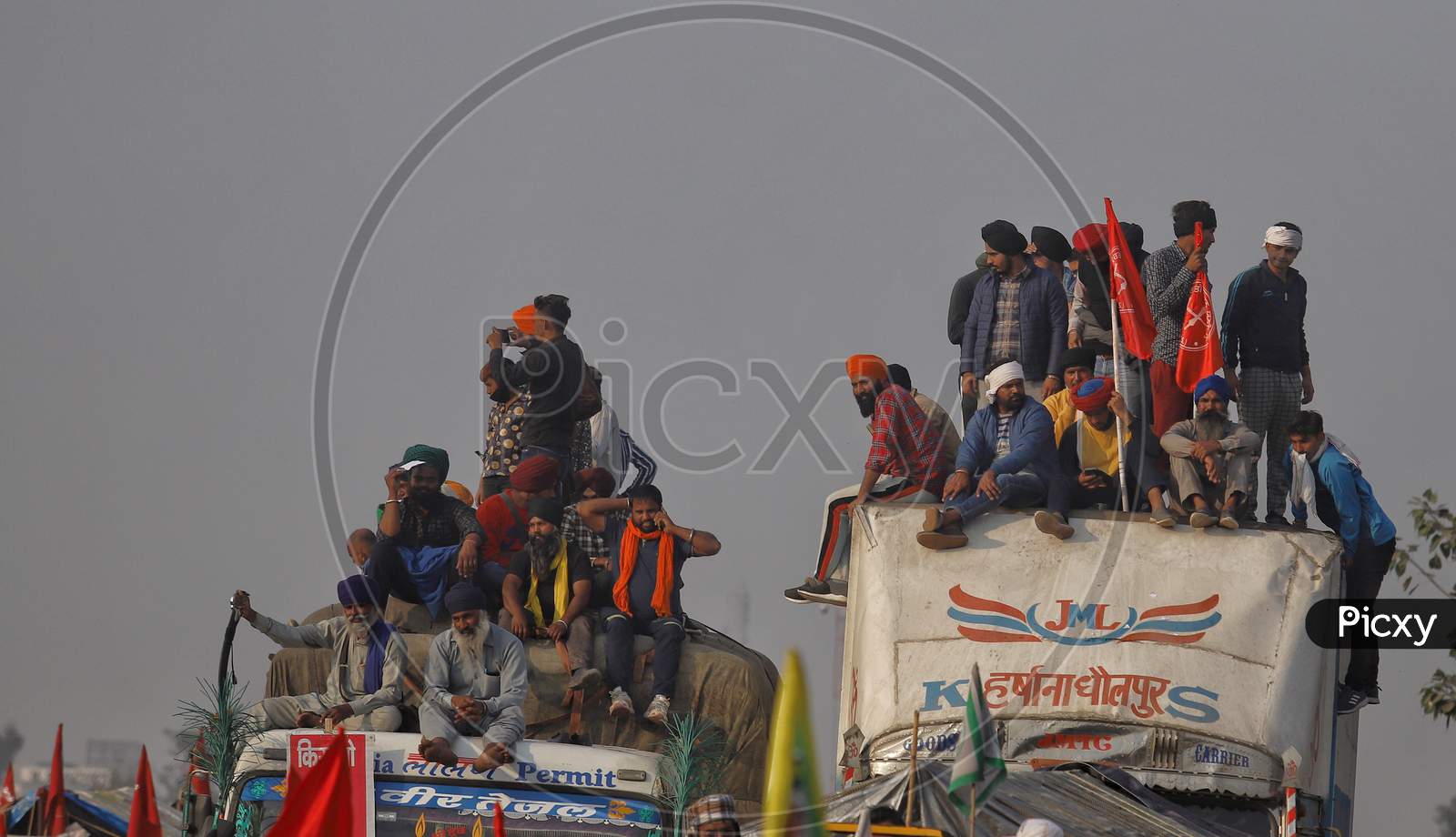 Farmers sitting on top of trucks at Singhu Border to protest centre's farm reform laws in New Delhi, India.