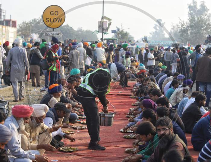 Farmers eat at Singhu Border as they protest centre's farm reform laws in New Delhi, India.