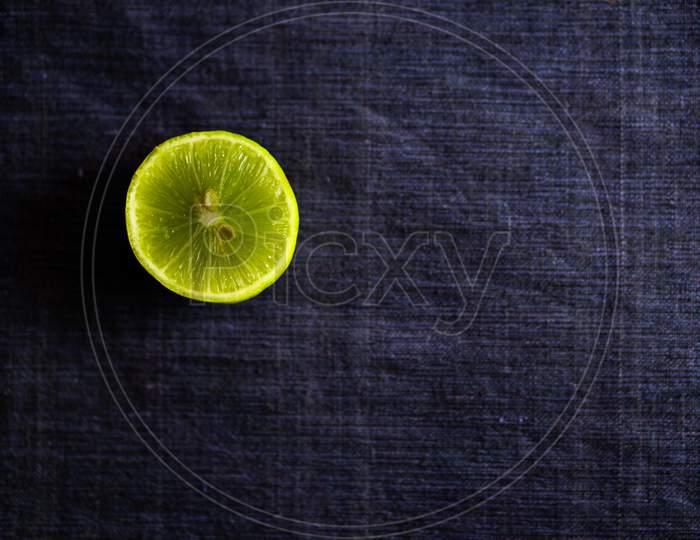 Vitamin Rich Fresh Lemon Piece On A Dark Blue Background