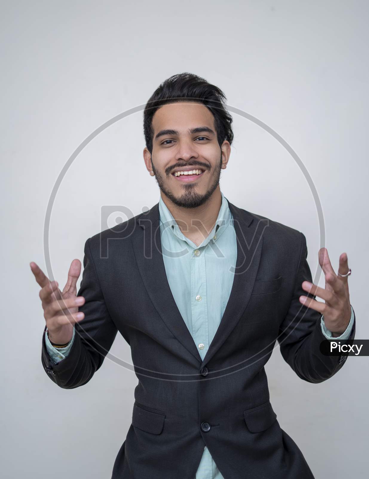 Image Of Handsome Young Man In Suit Smiling Keeping Arms Outstretched And Looking At Camera While Standing Against White Background Ps Picxy