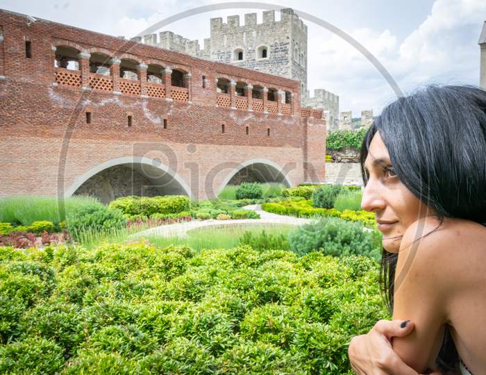 Portrait Of Caucasian Woman With Rabati Castle Tower And Fortification Wall Background