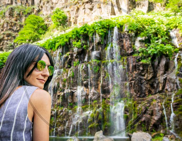Portrait Of Caucasian Woman Look To Camera With Dramatic Dashbashi Canyon Watefall In Background