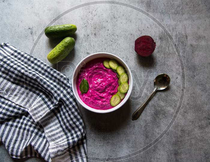 Beetroot dip and cucumber slices in a bowl