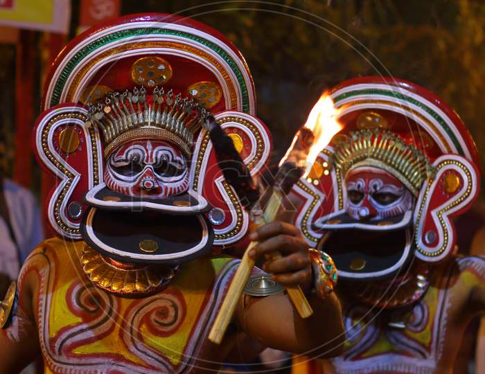 Colorful make up of a theyyam artist and expressions on face