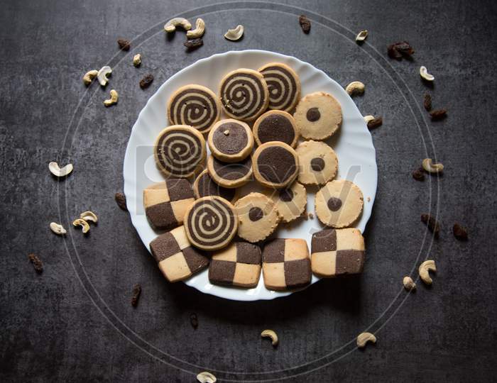 View from top of variety of cookies in a plate on a background