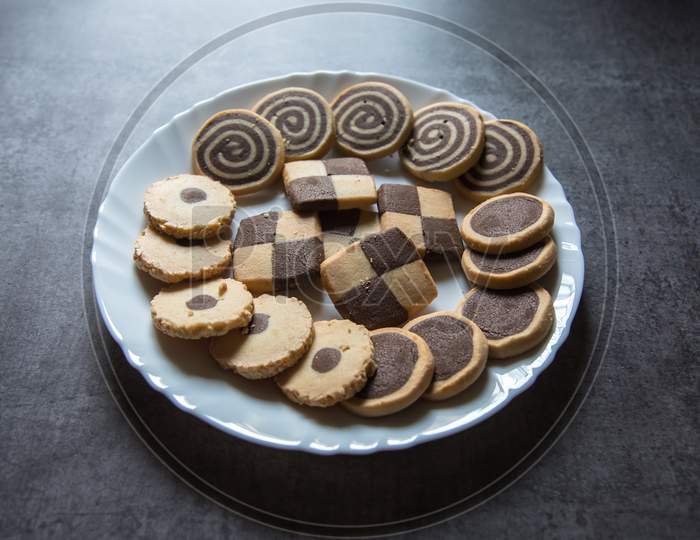 Close up of variety of chip cookies on a white plate