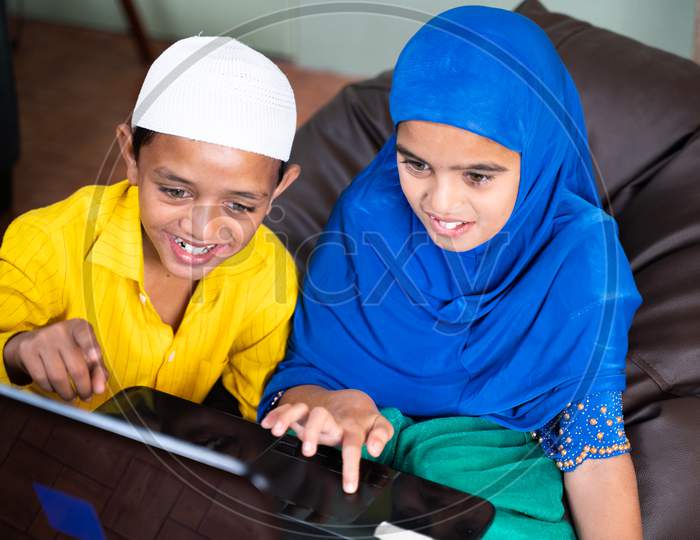 Two Muslim Teenager Kids Excited Over Using Laptop At Home - Concept Of Kids Using Modern Technology And Internet.