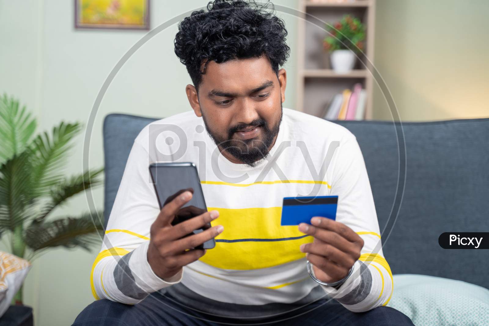 Young Man Entering Card Details On Mobile Phone For Online Purchase - Concept Of Digital Payment For Shopping, Internet Banking.