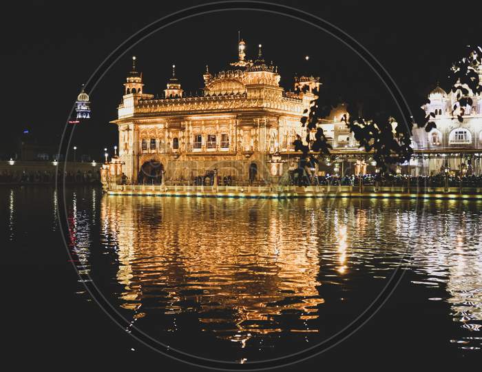 Night view of Golden Temple with its reflection in the river