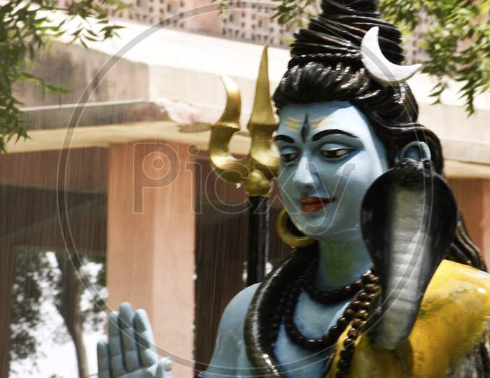 Statue of lord Shiva and Background raining