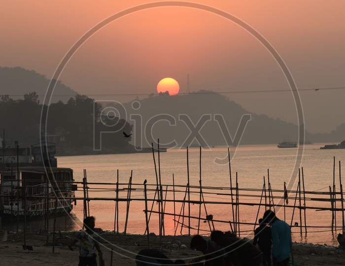 Childrens playing on the banks of river Brahmaputra during sunset in Guwahati on Monday, December 21, 2020.