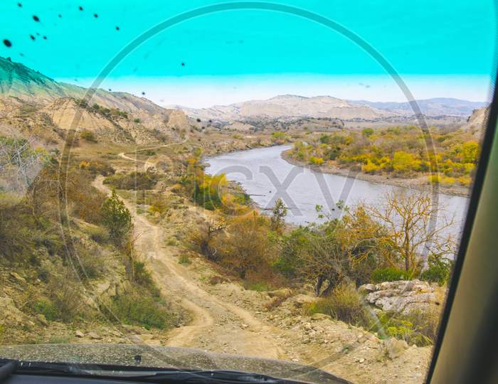 Passenger View From The Window Of Gravel Road And River In Vashlovani Protected Areas. 4Wd Tours Georgia