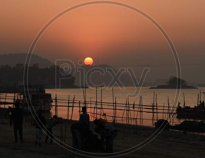 Childrens playing on the banks of river Brahmaputra during sunset in Guwahati on Monday, December 21, 2020.