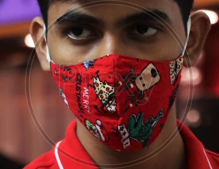 A boy is seen wearing a christmas themed mask at a mall, amid the spread of the coronavirus disease (COVID-19) in Mumbai, India, December, 2020.