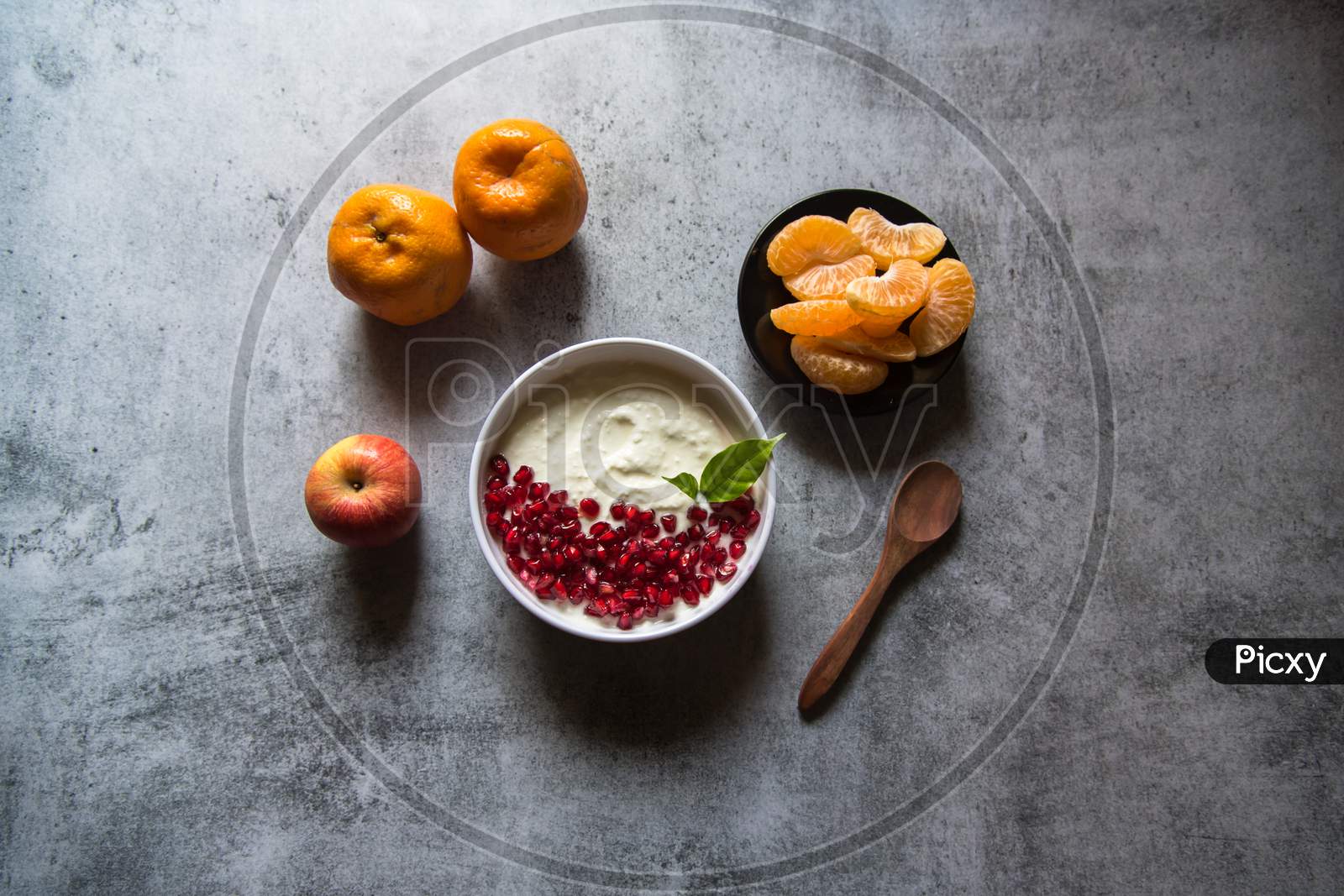 Fresh yogurt and pomegranate seeds in a bowl