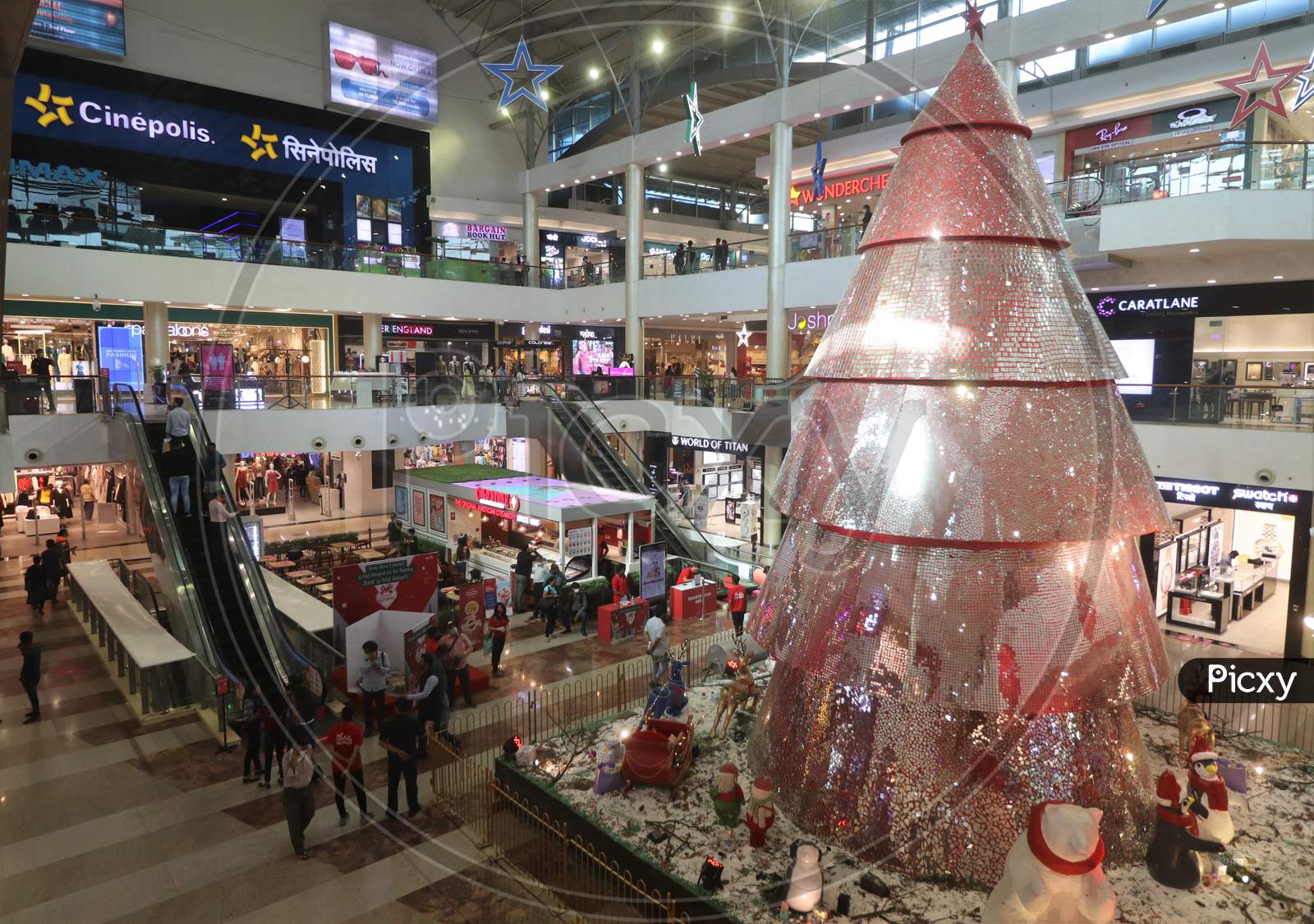People walk near Christmas decorations inside a mall, amid the spread of the coronavirus disease (COVID-19) in Mumbai, India, December, 2020.