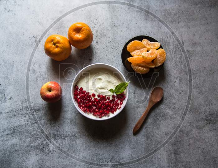 Fresh yogurt and pomegranate seeds in a bowl