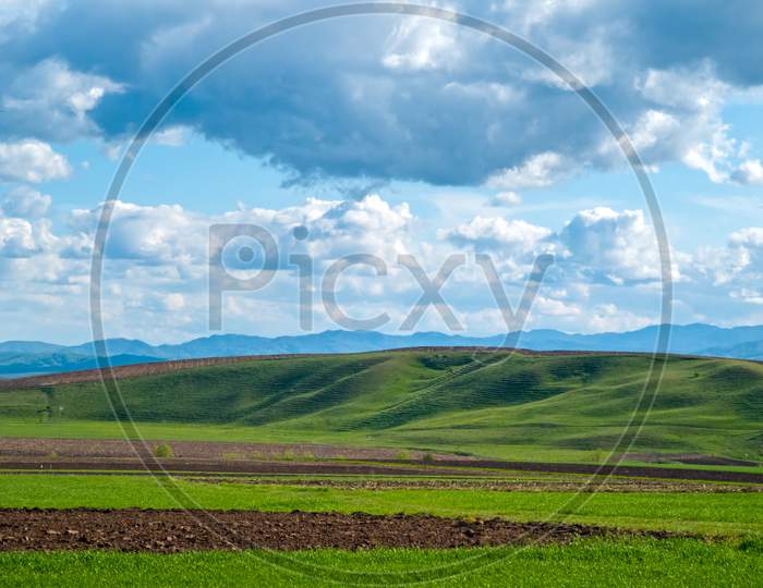 Rural Spring Scene, Fresh Green Fields And Hill