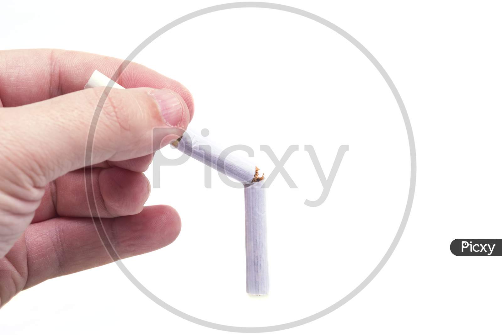 Hand Holding A Broken Cigarette