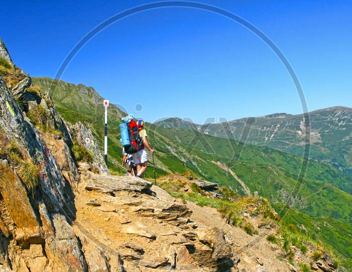 Hiking Teens On Mountain Trail