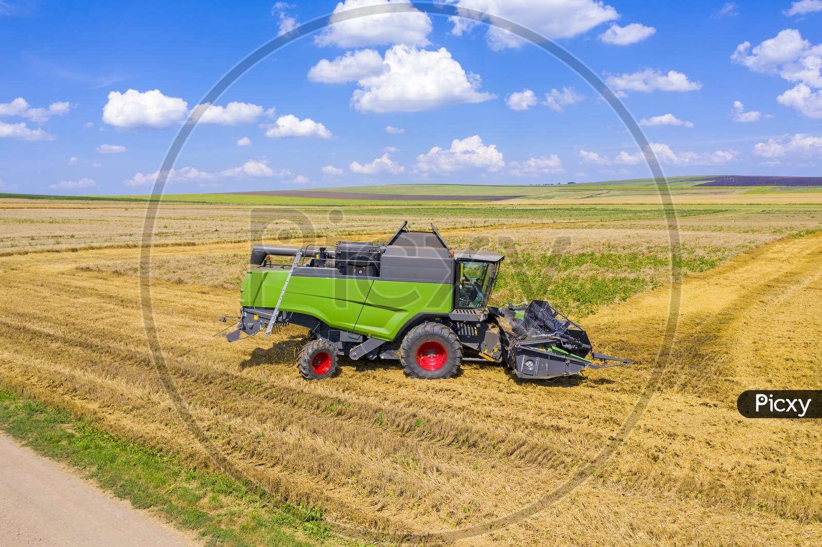 Combine Harvester Working In Wheat Field