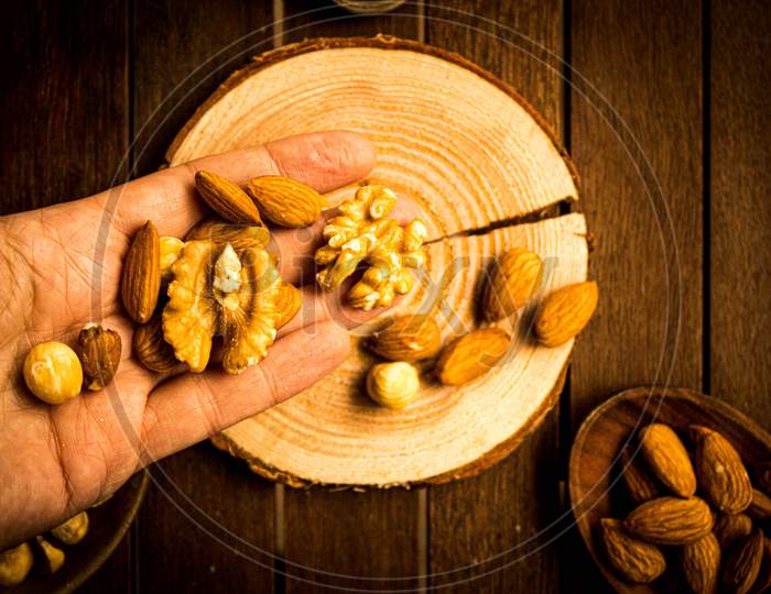 Mix Of Almonds, Walnuts And Hazelnuts On A Wooden Table