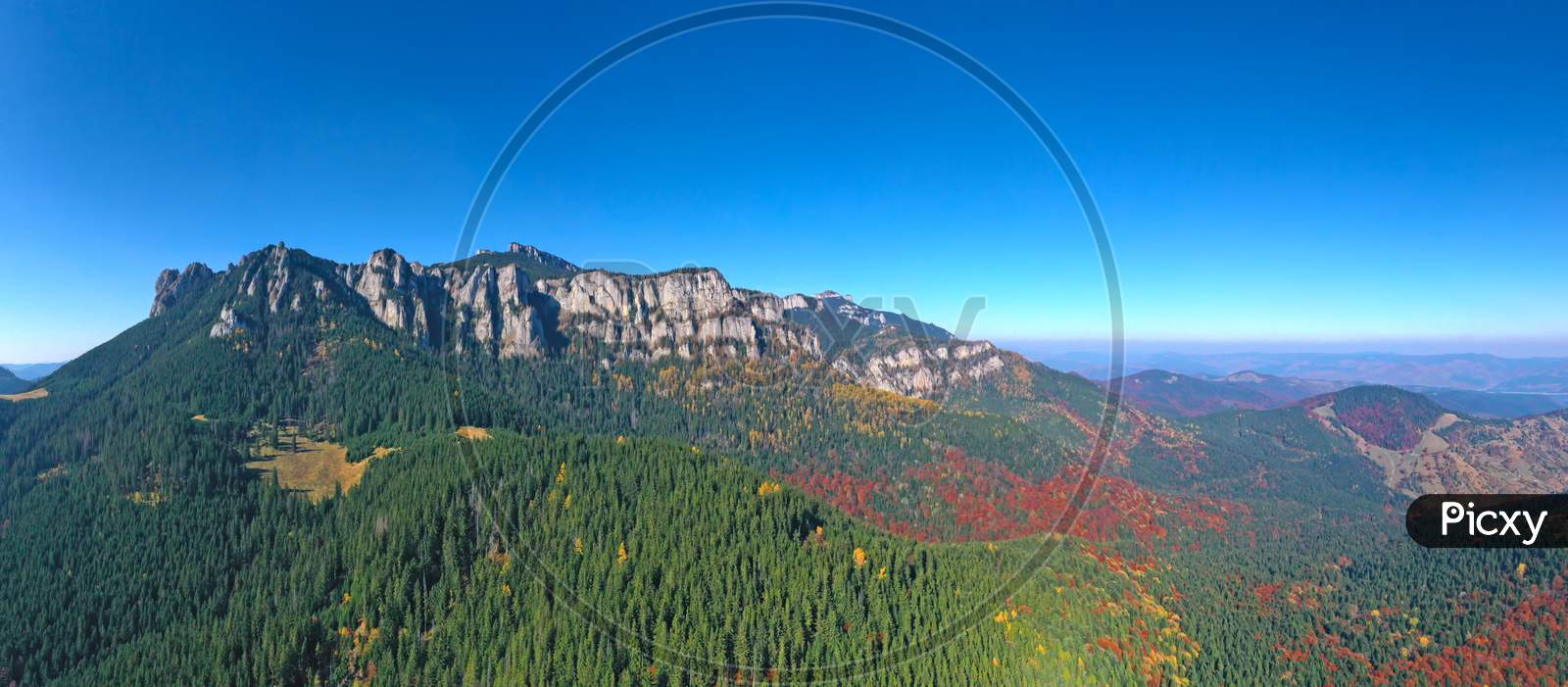 Aerial View Of Rocky Mountain And Colored Forest