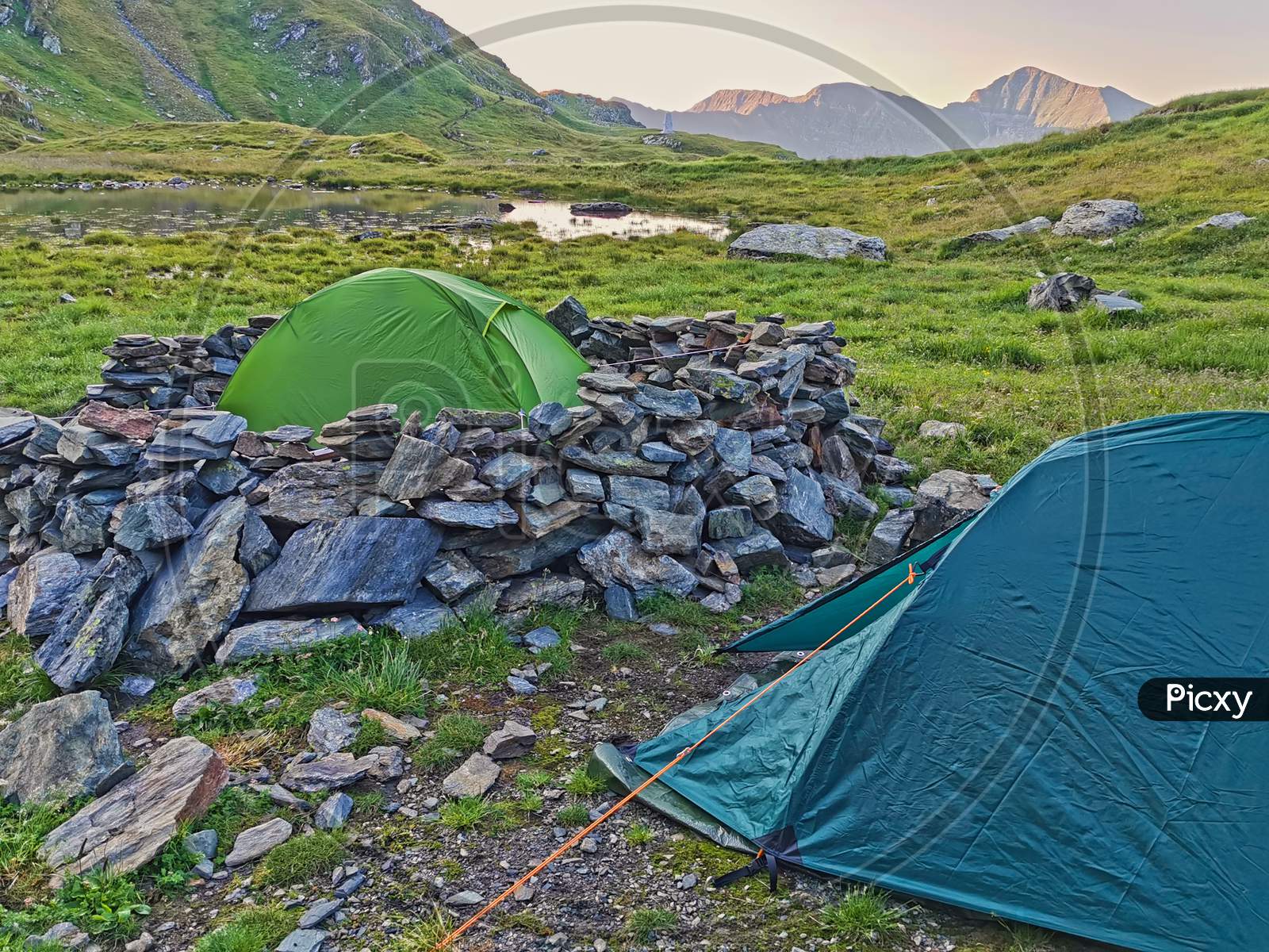 Alpine Tents In A Green Mountain Landscape