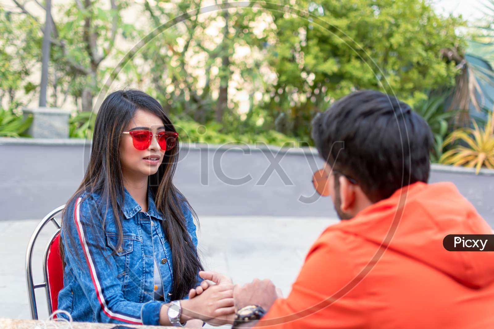 Young Indian Couple In Love Spend Time Together While Sitting At Table In Outdoor Cafe In Kolkata On December 2019