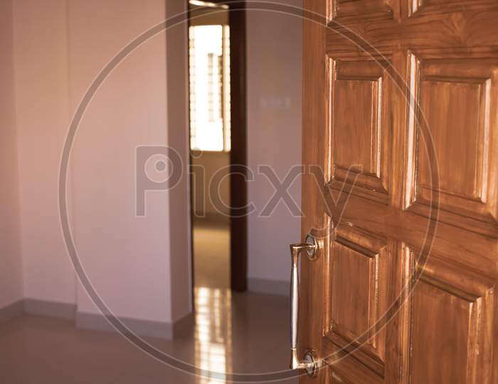 Polished And Designer Wooden Main Door Of An Apartment In A Building