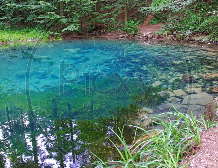 Clear Blue Mountain Lake In Forest