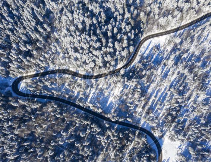 Curvy Road In Winter Forest, View From Above