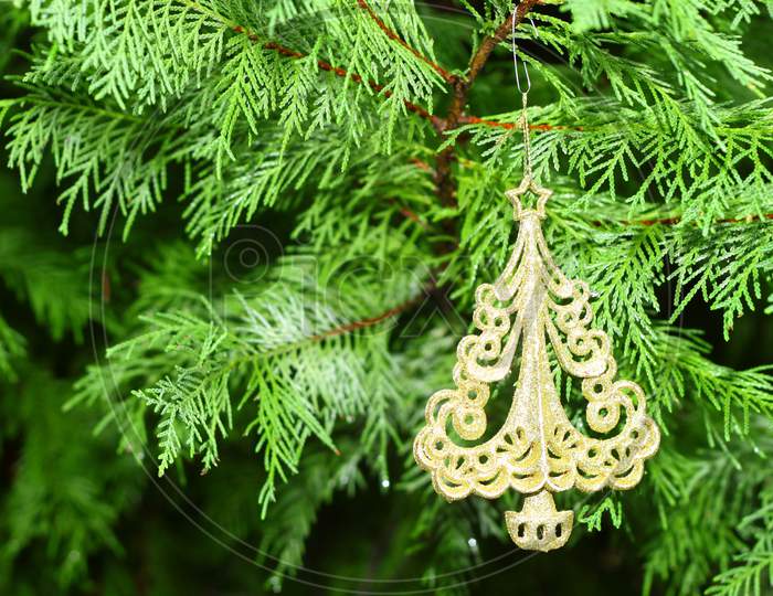 A Christmas Tree Ornament Hanging From A Christmas Tree