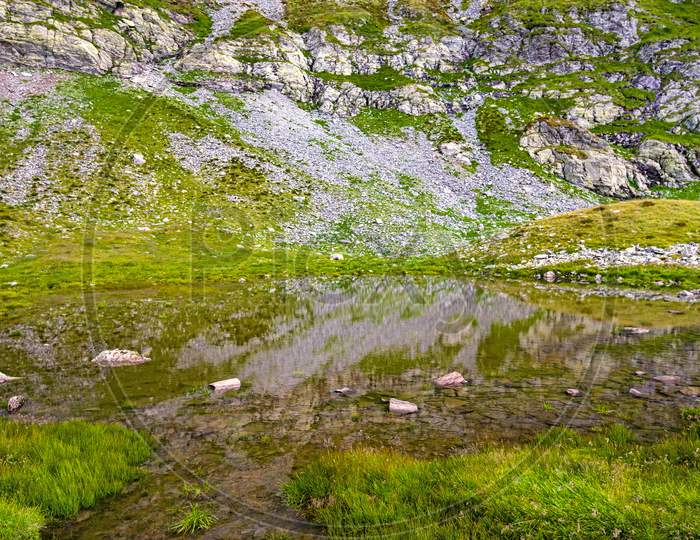 Clear Water Of Pond In Summer Mountain