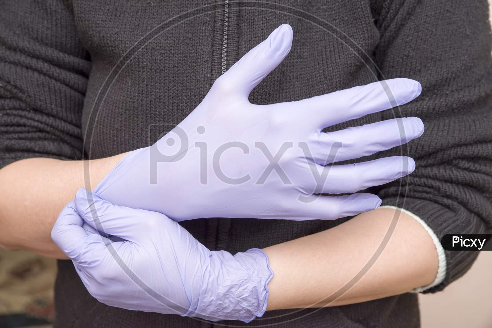 Woman Hand Wearing Latex Gloves