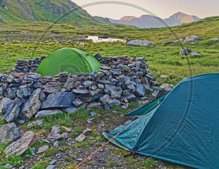 Alpine Tents In A Green Mountain Landscape