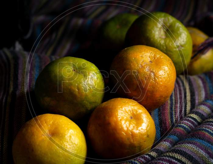 Heap Of Orange Fruit On A Dark Background