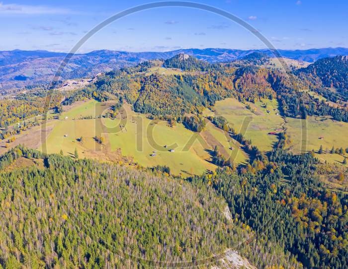 Aerial Meadows And Forest In Autumn Mountain
