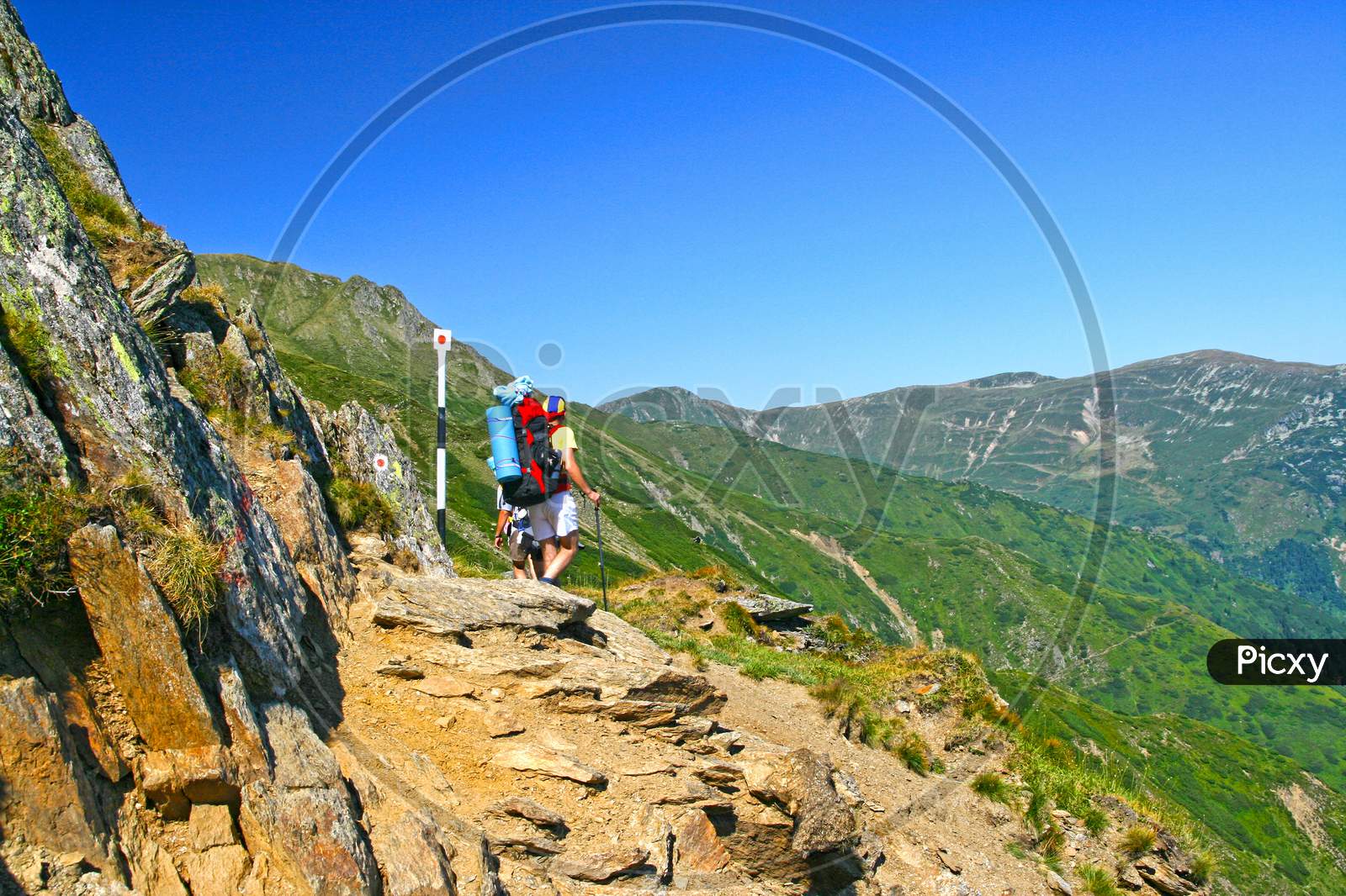 Hiking Teens On Mountain Trail
