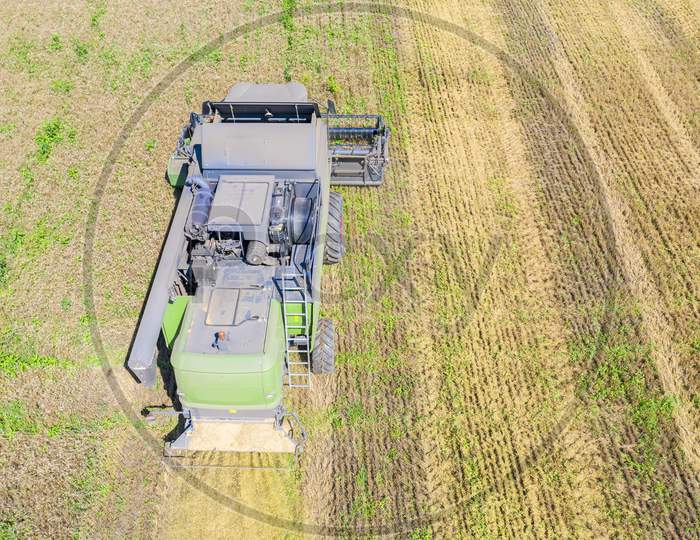 Above View Of Combine Harvesting Wheat Field