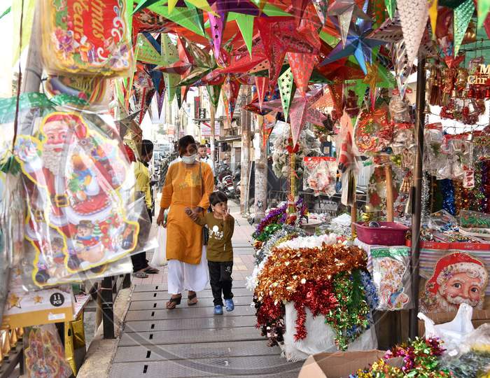 People walk past a shop selling decorative items ahead of Christmas, in Guwahati on Dec21,2020