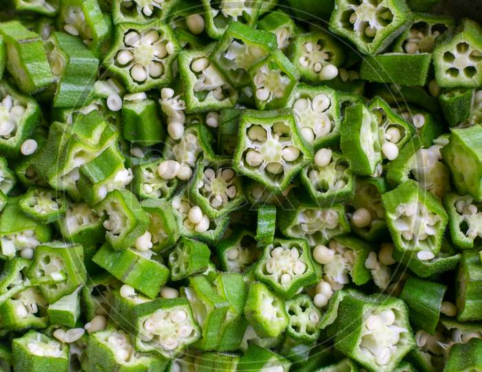 Background Of Freshly Chopped Green Vegetable Okra Or Okro Also Known As Ladies Fingers Or Orhro In Many Countries.