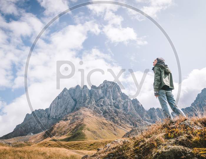 Female Caucasian Woman Stands Posing Looking Left With Scenic Background View