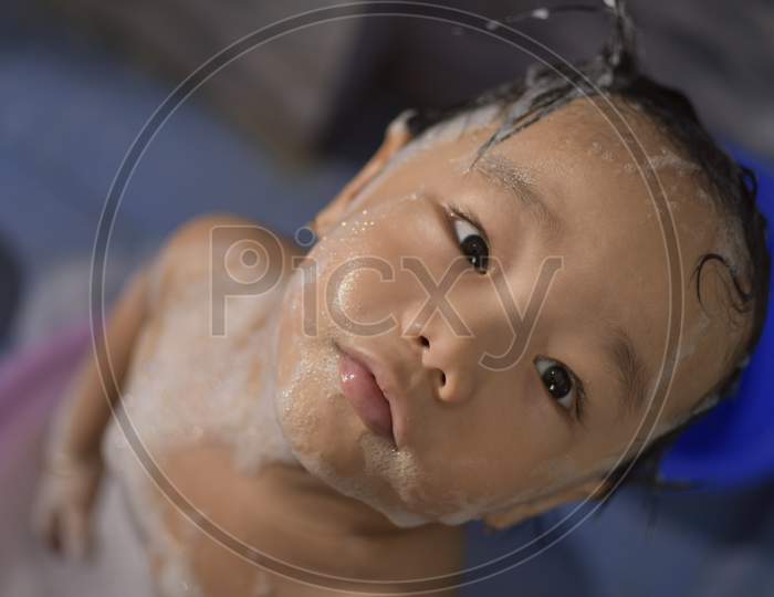 cute baby boy enjoying bubble bath